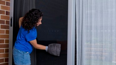 Woman cleaning a ForceField sliding security door